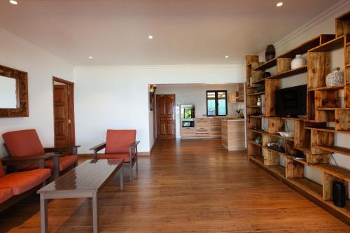 a living room with a couch and a table at Cote Mer villa in Baie Sainte Anne