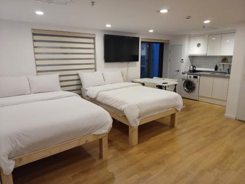 a hotel room with two beds and a kitchen at 318 Stay in Seoul