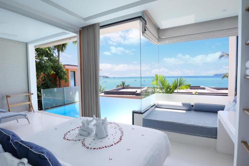 a bedroom with a view of the ocean at Bandara Villas, Phuket in Panwa Beach