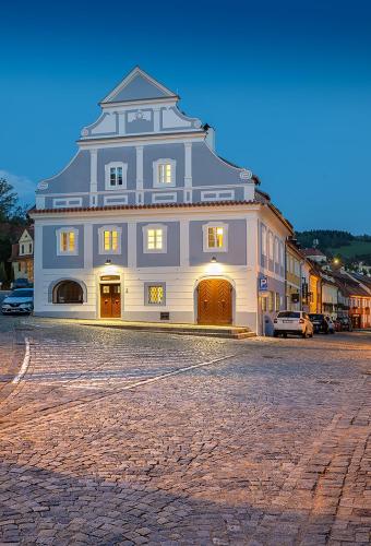 a large building with a clock on the top of it at Penzion KOVÁRNA in Český Krumlov