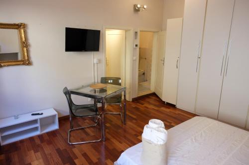 a bedroom with a table and a bed and a table and chair at Ludo’s Home in Florence