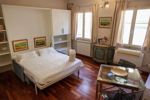 a bedroom with a bed and a glass table at Ludo’s Home in Florence