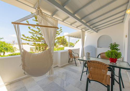 a room with a hammock on a balcony at Maroussa Studios in Agia Anna Naxos
