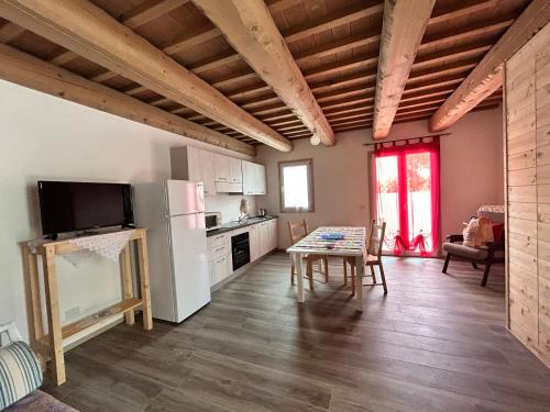 a kitchen with a refrigerator and a table in a room at Agriturismo Collamato in San Severino Marche