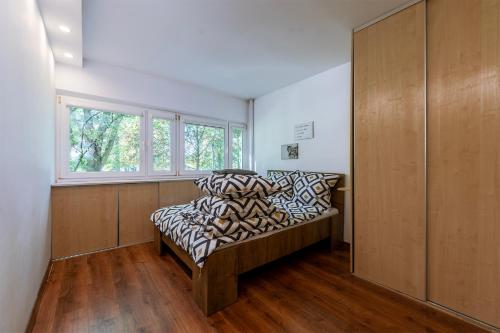 a bedroom with a bed with pillows and a window at Cosy&Bright TeofilowDistrict in Łódź