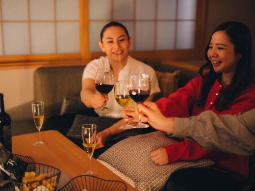 a group of people sitting around a table with wine glasses at MIMARU Tokyo Kinshicho in Tokyo