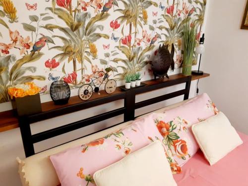 a couch in a room with a floral wall at B&B La Delice in Dalmine
