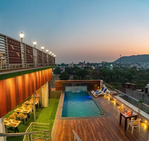 a rooftop pool on the roof of a building at Pax Grand Blue in Udaipur