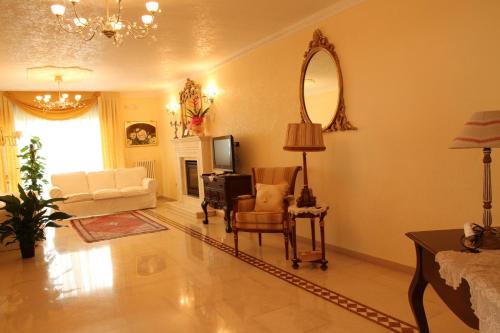 a living room with a couch and a mirror at B&B il Castello in Vico del Gargano