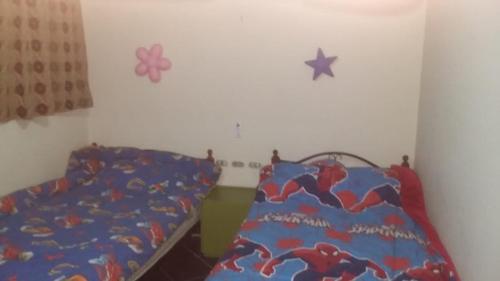 a bedroom with a bed with a spider man bedspread at Chalet Porto El Sokhna Panorama area -2 bedroom- excellent view شاليه ببورتو السخنة - منطقة البانوراما - غرفتين وريسبشن فيو البسين والجولف والجبال والبحر- Family & young people over 30 years only in Ain Sokhna