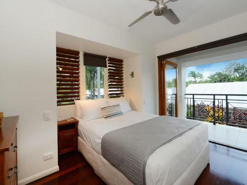 1 dormitorio con cama y ventana grande en 7 Templemoon, en Port Douglas
