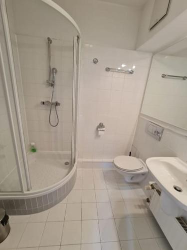 een badkamer met een douche, een toilet en een wastafel bij Fantastic - Z6 Room - 101A in Warschau