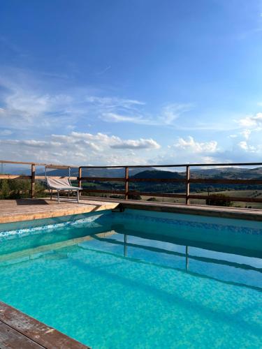 a swimming pool with a view of the ocean at Agriturismo Collamato in San Severino Marche
