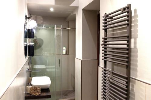 a bathroom with a glass shower and a toilet at La casa di Alice in Parma