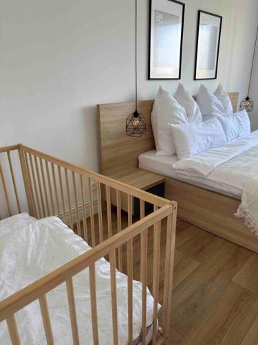 a bedroom with two beds and a crib at U-sleep : appartement 2 chambres in Liège