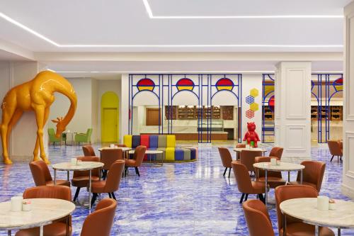 a restaurant with tables and chairs and stained glass windows at Neverland City Hurghada - Pickalbatros in Hurghada