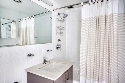 a bathroom with a sink and a shower curtain at Back Bay 2br w gym nr Prudential Center BOS-299A in Boston