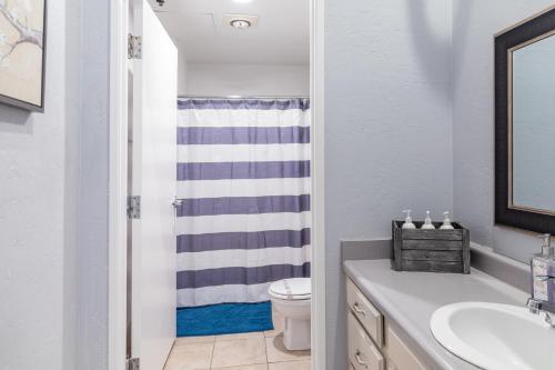a bathroom with a sink and a toilet at Greely Gaslamp - Loft W Parking & 3 Beds #202 in San Diego