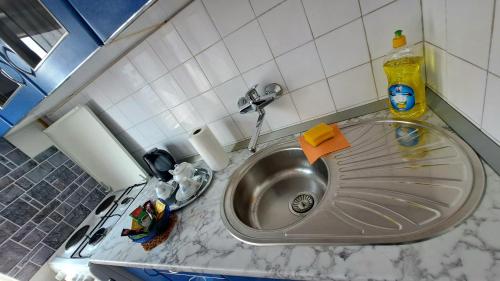 a kitchen counter with a sink in a kitchen at Apartman Bella Ilidža in Sarajevo