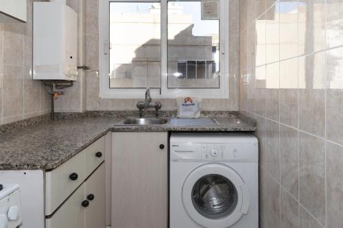 a kitchen with a washing machine and a sink at Estirpe, 3º-6 in Cullera