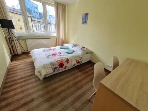 a small bedroom with a bed and a table at Fantastic - Z6 Room - 103B in Warsaw