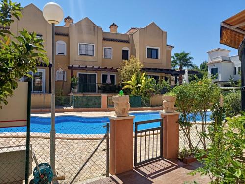 a villa with a swimming pool in front of a house at House Laguna Roja in Torrevieja