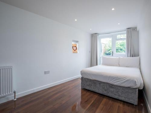 a small bedroom with a bed and a window at Pass the Keys Spacious 3 Bed by River Thames Old Windsor in Windsor