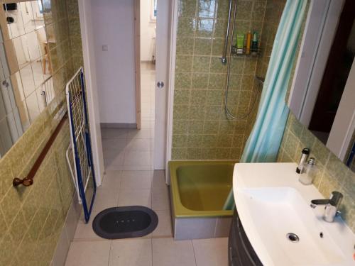 a bathroom with a sink and a shower and a tub at Nice Apartment in Mörfelden in Mörfelden-Walldorf
