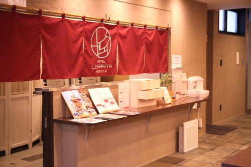 a counter with a red flag in a room at HOTEL LEGASTA KYOTO SHIRAKAWA SANJO in Kyoto