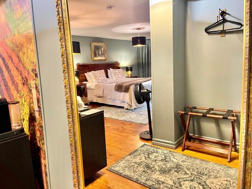 a mirror in a room with a bed at Sydkustens at Pillehill in Skivarp