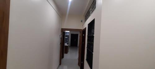 a hallway with white walls and a ceiling at The Candy Nest in Rānchī