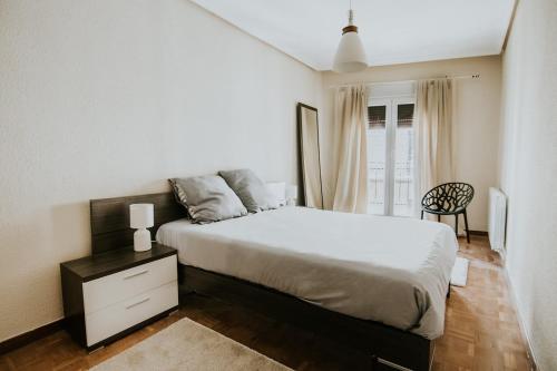 a bedroom with a bed and a chair in it at 1880 HAROs OLD TOWN HOUSE in Haro