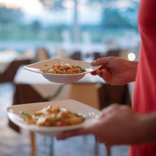 a person is holding a plate of food at Arcadia Agriturismo in San Nicola Manfredi