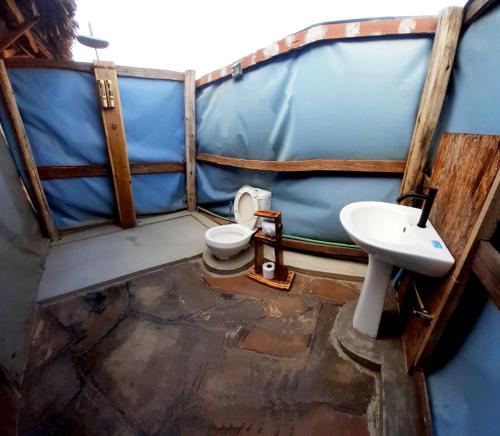 a bathroom with a toilet and a sink at Amanya Zebra 1-Bed Wigwam in Amboseli in Amboseli