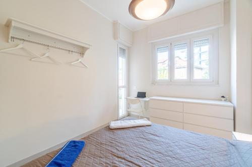 a white bedroom with a bed and a bath tub at Asti Comfy Apartment - Private Parking! in Asti