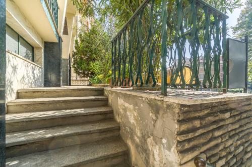 a set of stairs with a gate on a house at Asti Comfy Apartment - Private Parking! in Asti