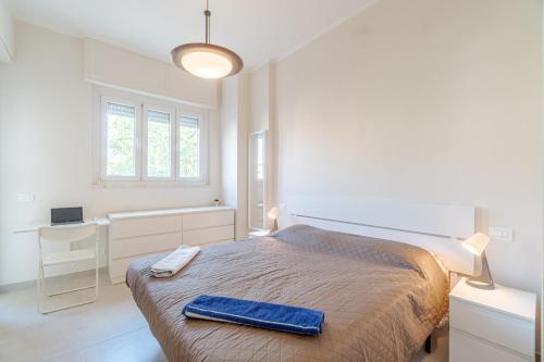 a bedroom with a bed with a blue towel on it at Asti Comfy Apartment - Private Parking! in Asti