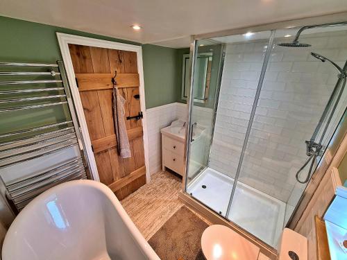 a bathroom with a shower and a sink and a tub at Finest Retreats - Ingleside Cottage in Whitby
