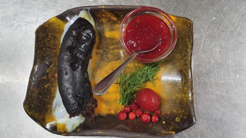 a plate of food with meat and a drink at Zirgu sēta "Klajumi" - Horse ranch "Klajumi" in Kaplava