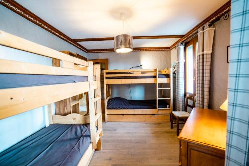 Zimmer mit Etagenbetten und einem Schreibtisch in der Unterkunft Chalet LouBochu Châtel Réservation in Châtel