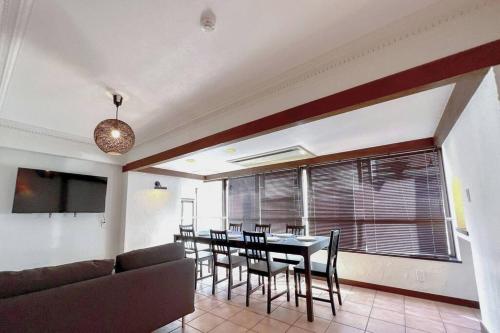 a dining room with a table and chairs and a couch at NEW OPEN 4BR, 110㎡ Walk to Asakusa in Tokyo