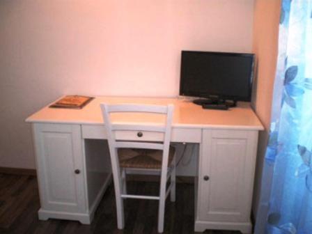 a white desk with a computer monitor and a chair at Conero Ranch in Porto Recanati