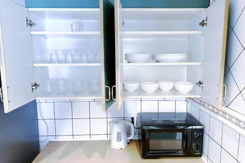 a kitchen with a toaster oven and white dishes at NEW OPEN 4BR, 110㎡ Walk to Asakusa in Tokyo