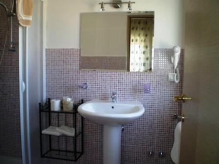 a bathroom with a sink and a mirror at Conero Ranch in Porto Recanati