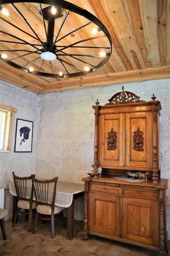 a dining room with a table and a chandelier at Zirgu sēta "Klajumi" - Horse ranch "Klajumi" in Kaplava