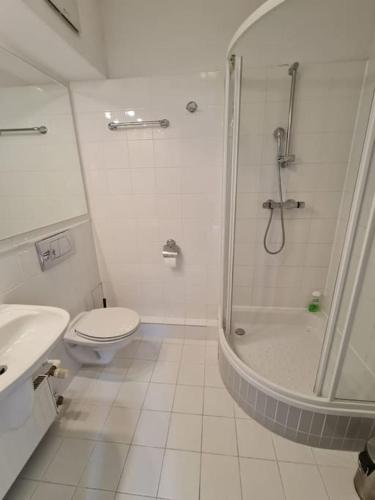 a white bathroom with a shower and a toilet at Fantastic - Z6 Room - 204A in Warsaw