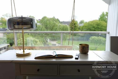 a desk with a book and a tv on a window at Harmony House in Handewitt
