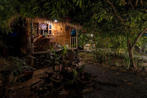 a small house with a porch at night at Kampot Cabana in Kampot