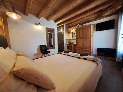 a bedroom with a large bed and a desk at Chalet Augustin in Vaujany