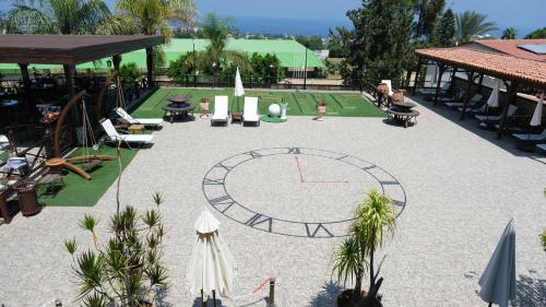 a large courtyard with a clock in the middle at Bella View Art Boutique Hotel in Kérynia